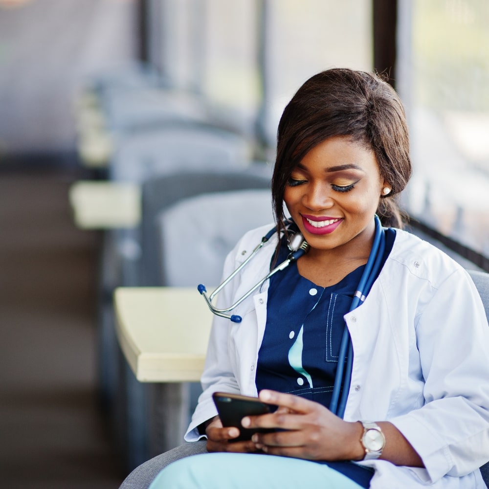doctor looking at mobile device learning academies clinical education